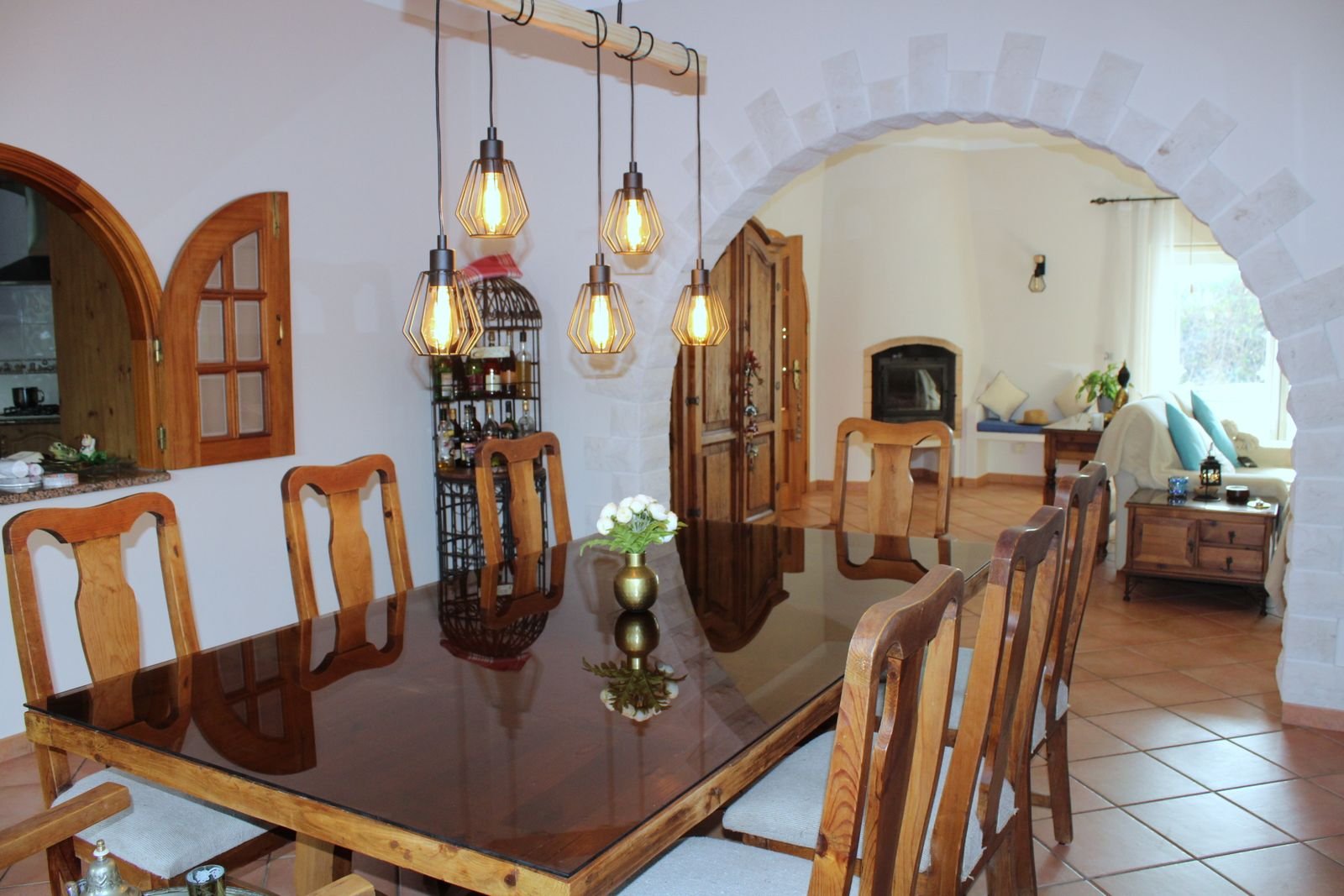 Dining room with a long wooden table and pendant lights