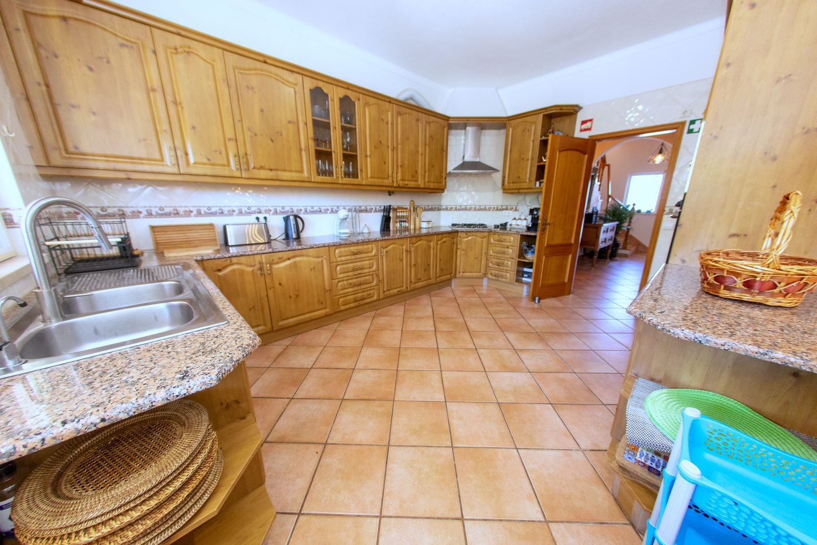 Fully equipped kitchen with wooden cabinets and granite worktops