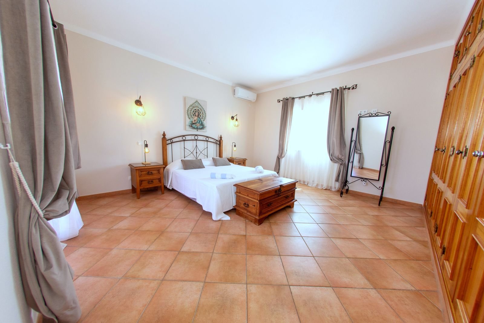 First floor master bedroom with a double bed and wooden wardrobes