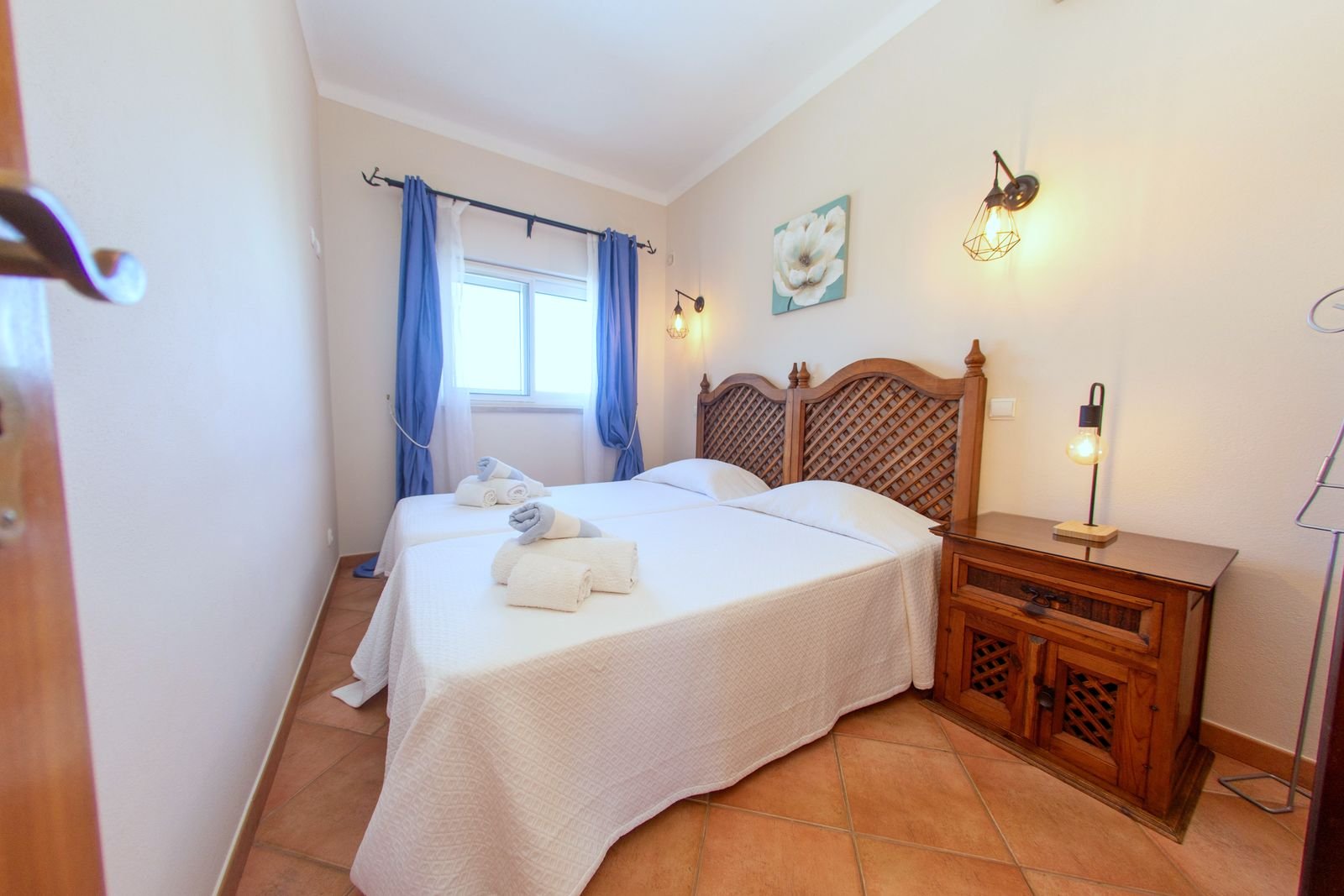 First floor twin bedroom with two single beds and blue curtains