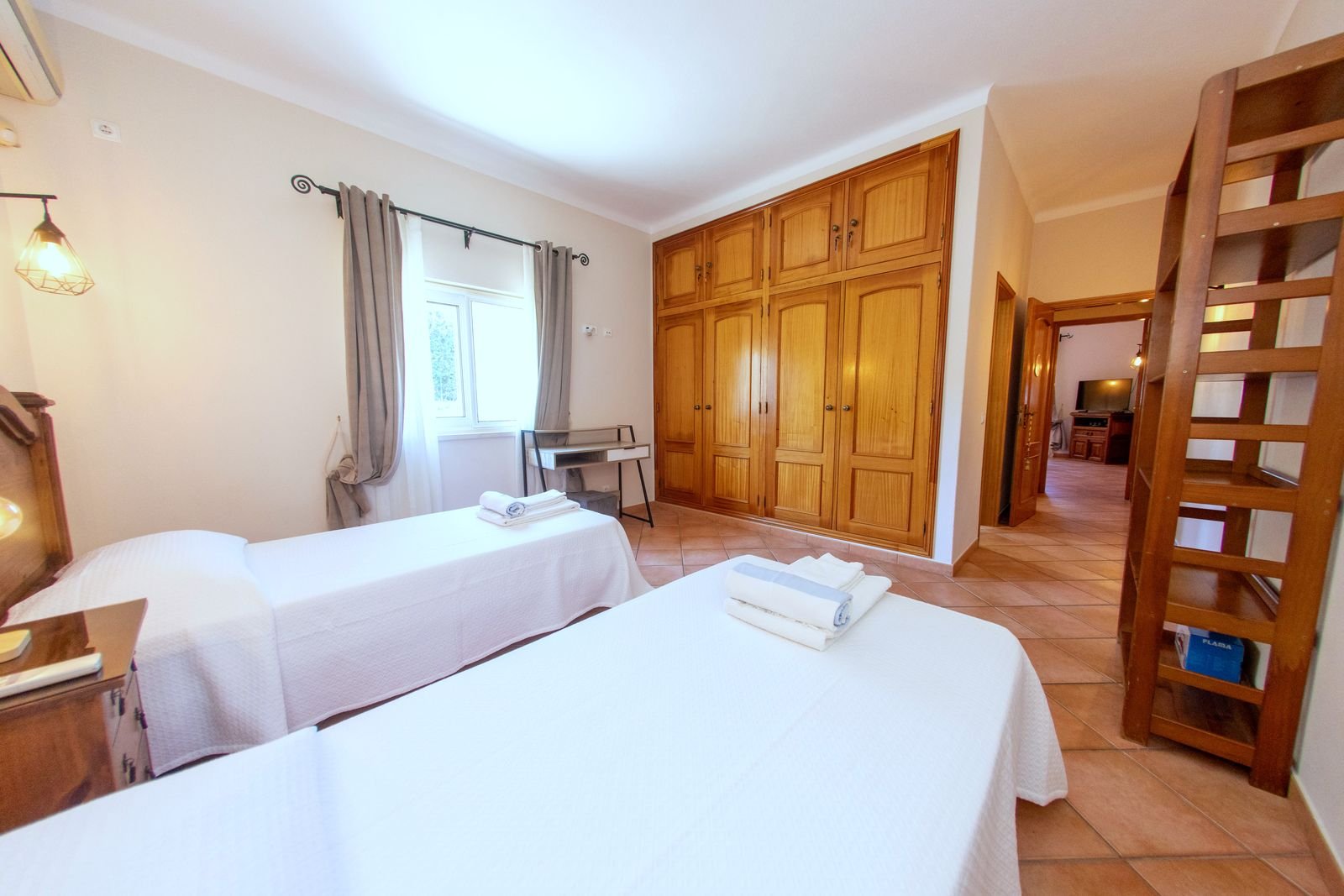 Ground floor twin bedroom with two single beds and a desk